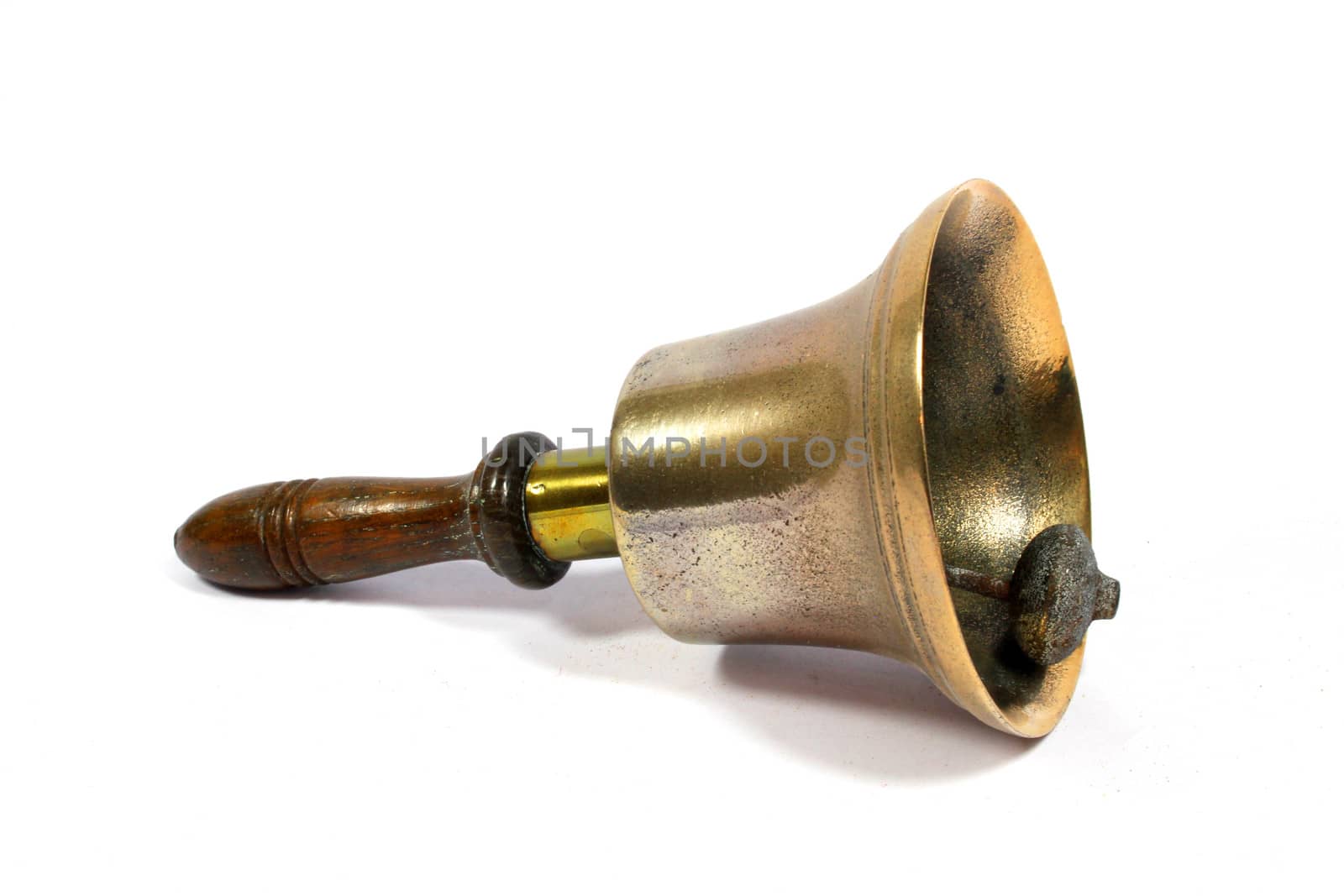 A Vintage Brass School Bell On White Background
