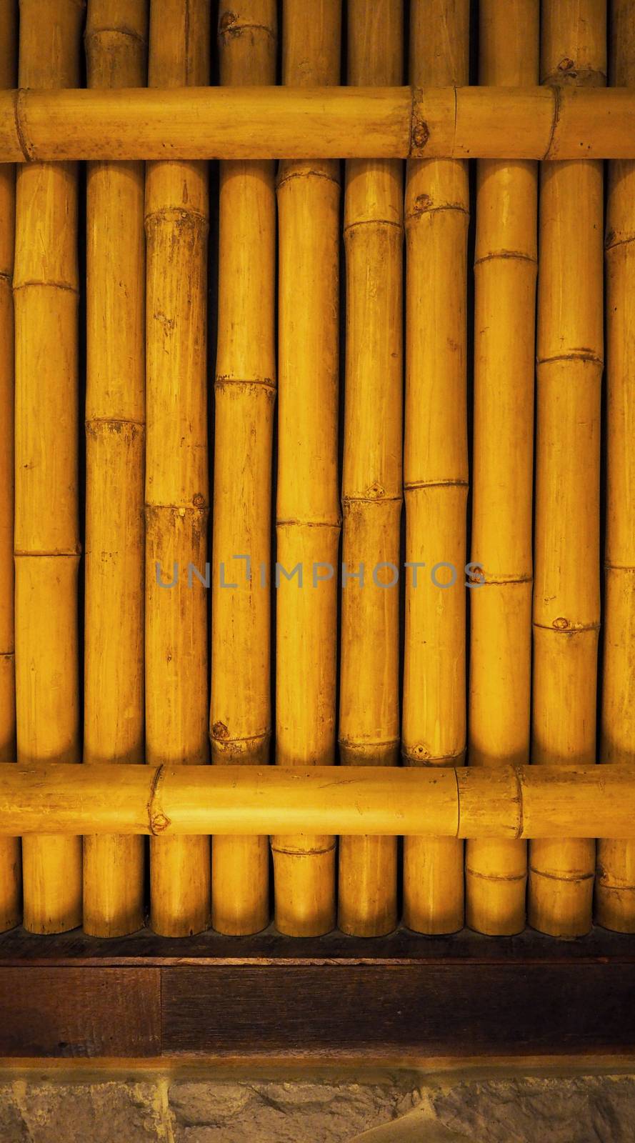 Old dirty bamboo background wall from real nature to home decor interior and light on for texture and japanese style.