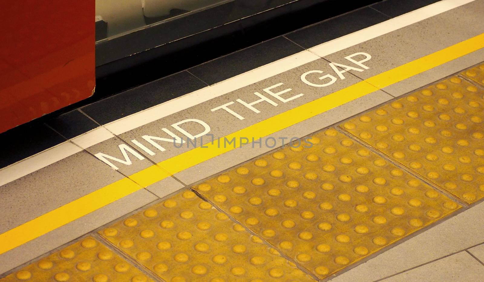 Mind the gap sign on the subway train platform. by gnepphoto