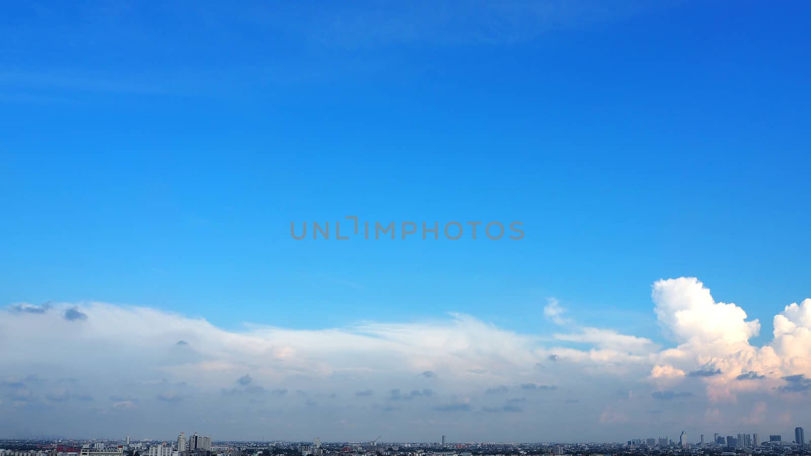 Blue sky and white clouds and landscape of city building in evening time.