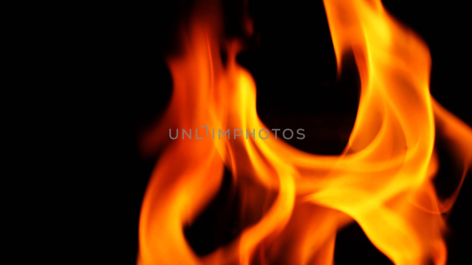 Yellow orange and red color of fire is flamming and burning the heat on black background and close-up shot.