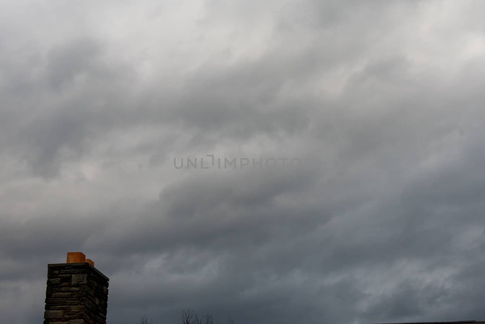 A Brick Chimney on a Cloudy Overcast Sky by bju12290