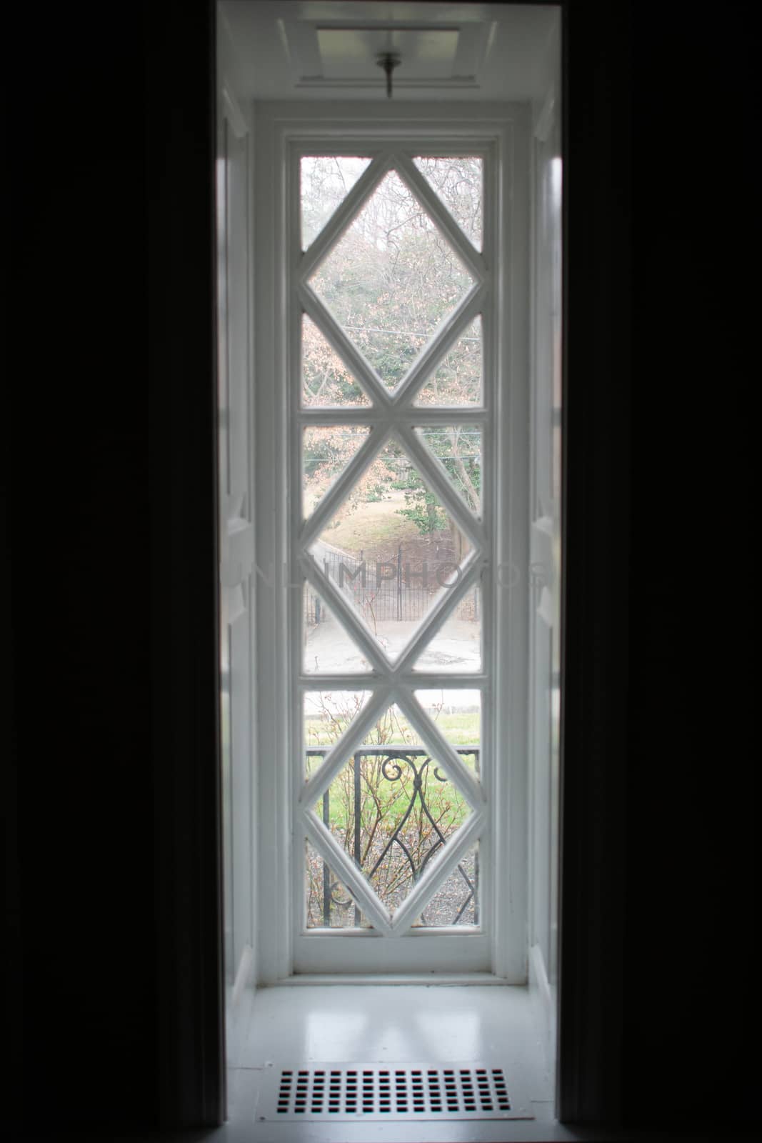 A Long Rectangular White Window With A Diamond Pattern