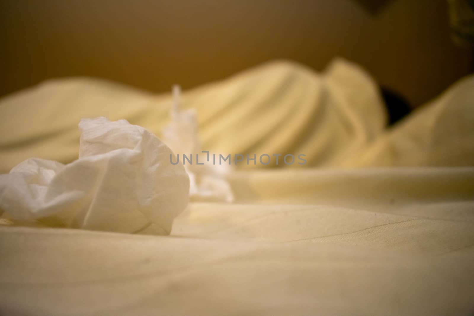 A Young Man in a White Shirt Lying in Bed Sick With Dirty Tissues