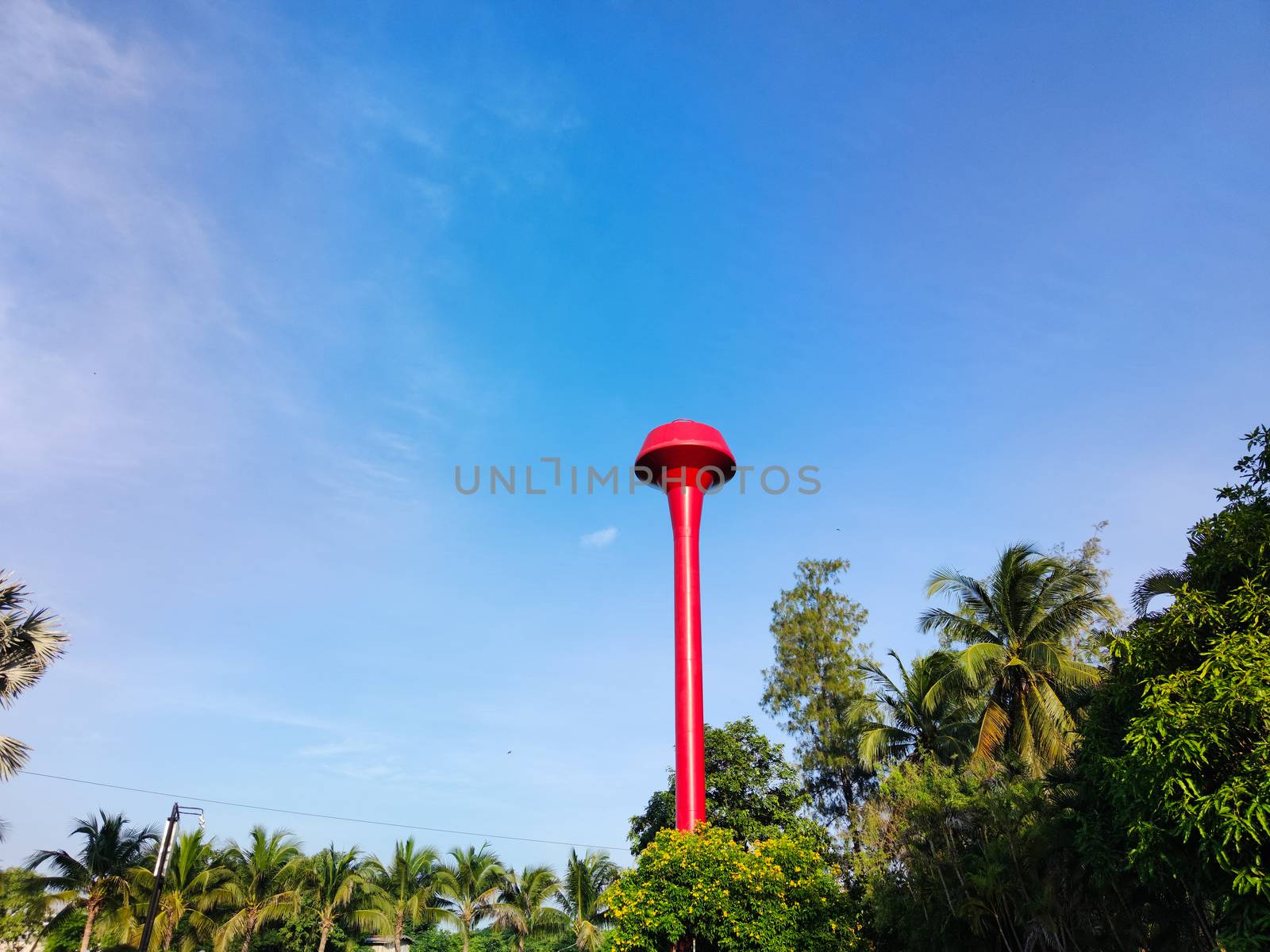 red thai water tower tank with blue sky with copyspace