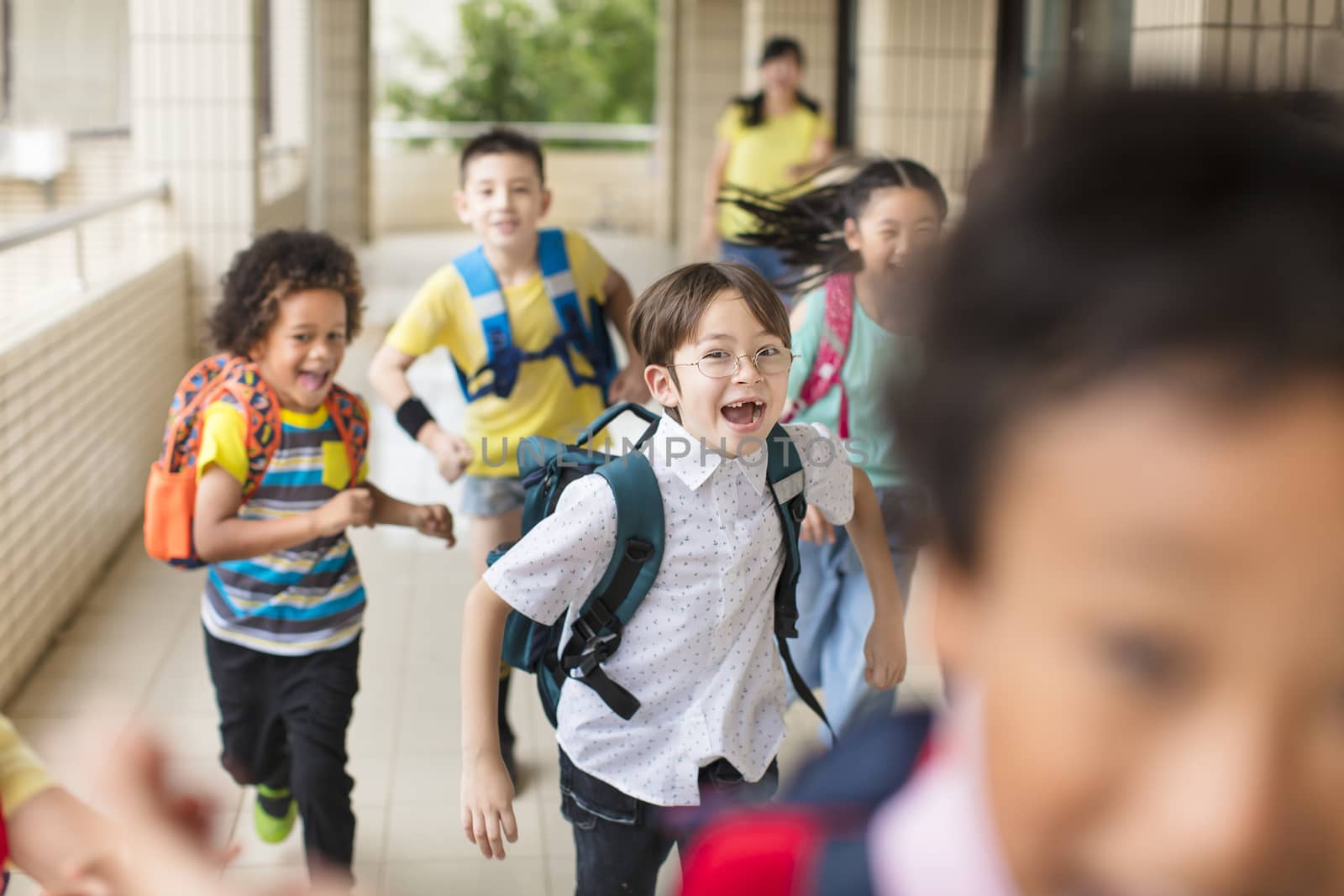 happy Group of elementary school kids running forward by tomwang