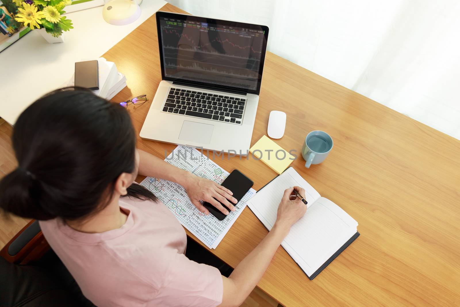 Business women use laptop analysis stock market chart. Business people use laptop trade sell and buy stock market at home. Business work at home comcept.