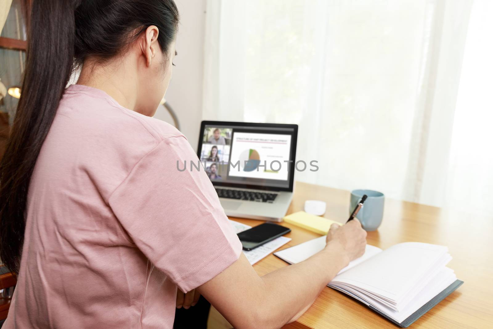Asian business women working at home online meeting with video conference on computer. Business people using computer online meeting and speaking with team group.