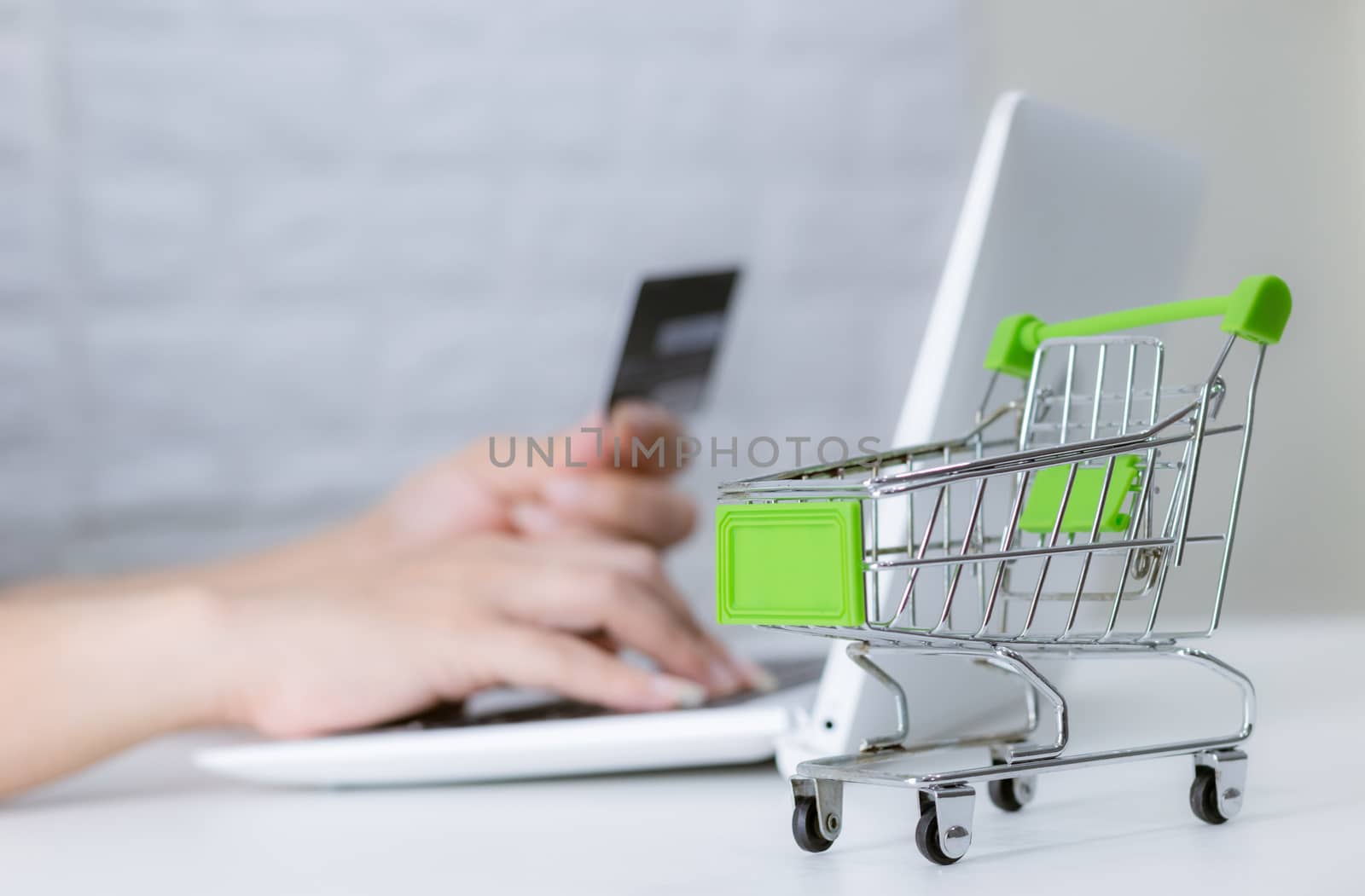 Hands holding credit card on the keyboard online shopping on laptop