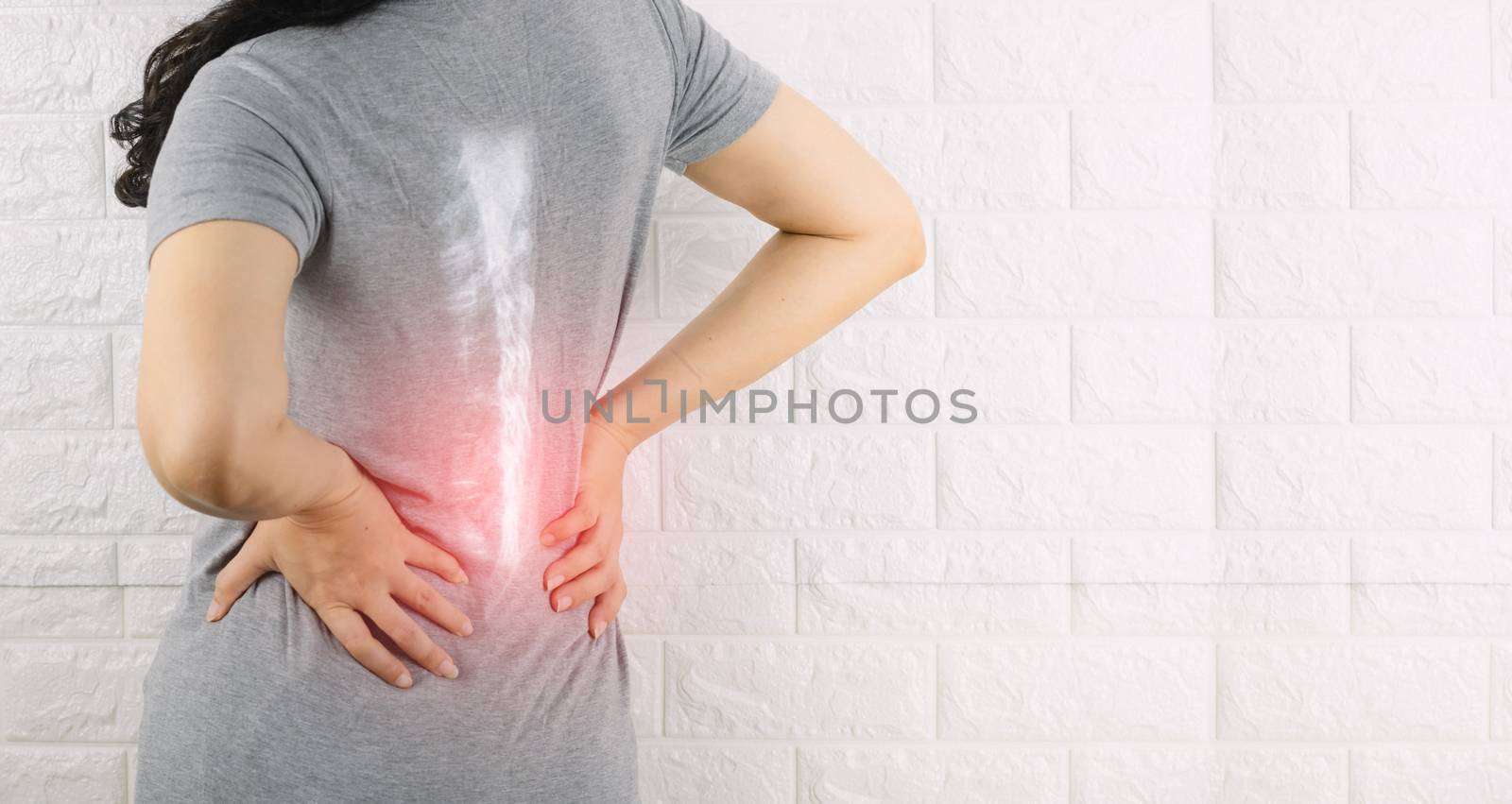 A woman holding the waist with pain spine bone
