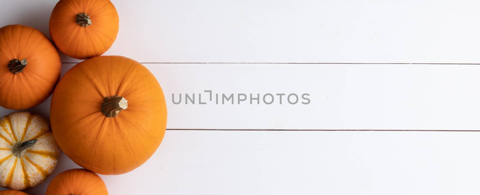 Orange pumpkins on white wooden background , Halloween concept , top view with copy space for text