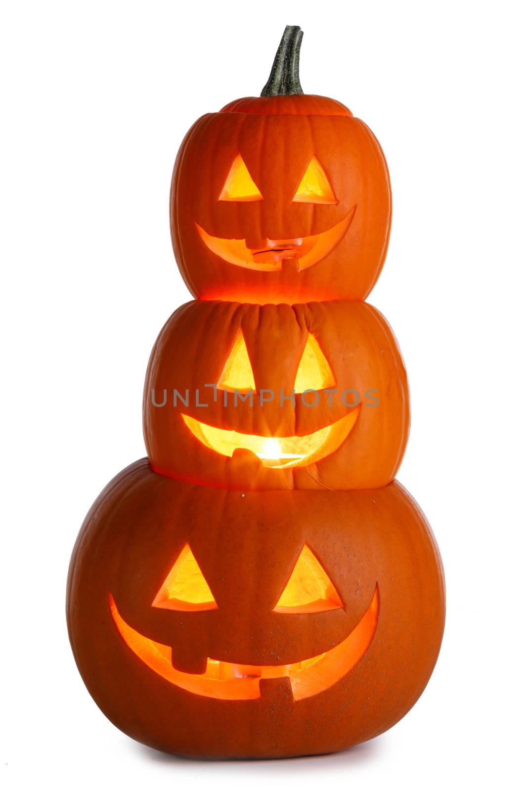 Pile of glowing Carved Halloween Pumpkins isolated on white background