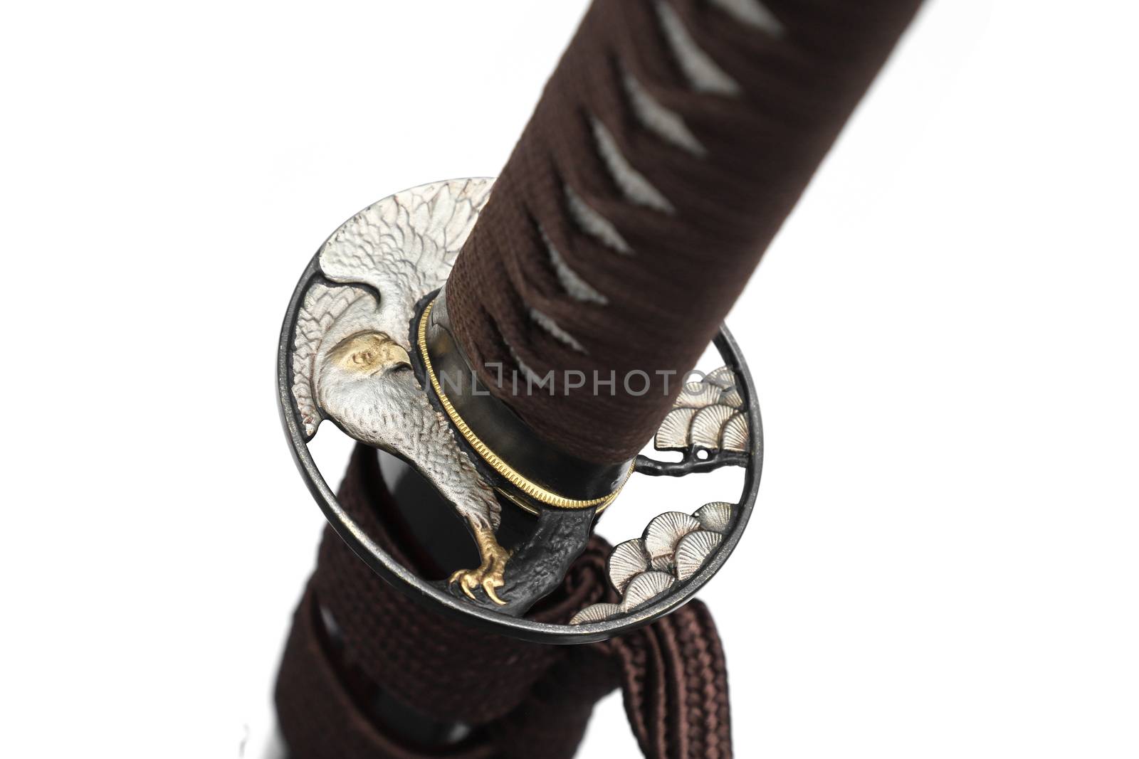 Tsuba is a hand guard of Japanese sword made of steel​ isolated in white background. Selective focus.