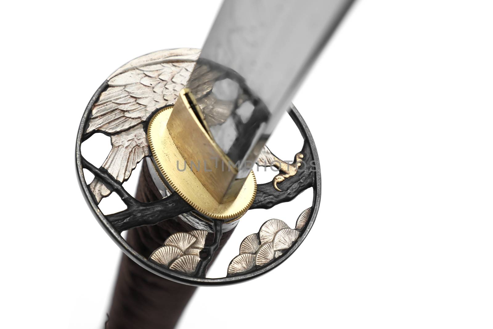 Tsuba is a hand guard of Japanese sword made of steel​ isolated in white background. Selective focus.