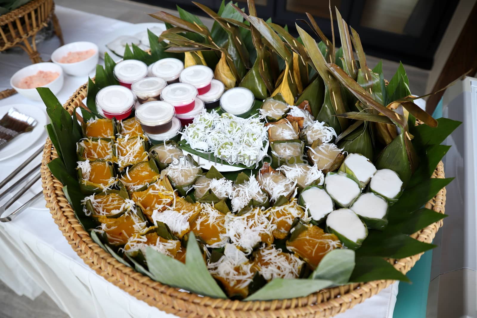 Thai desserts, beautiful colors, often packed with banana leaves. And sprinkle with grated coconut. Selective focus. by joker3753