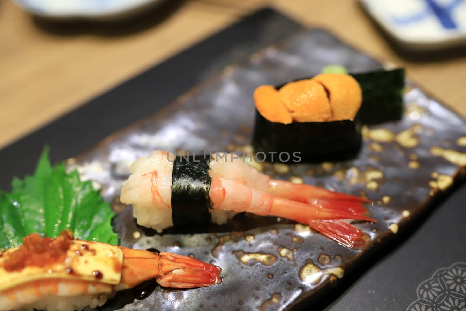Shrimp sushi  on a traditional Japanese plate in a Japanese restaurant. Selective focus. by joker3753