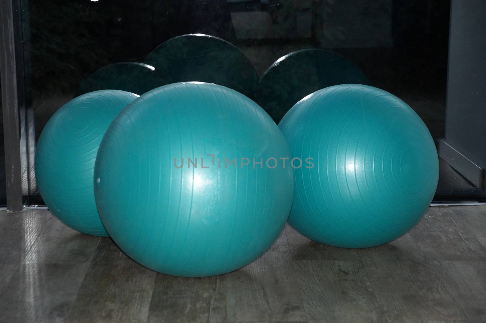 fitness balls by the window in the gym close up by Annado