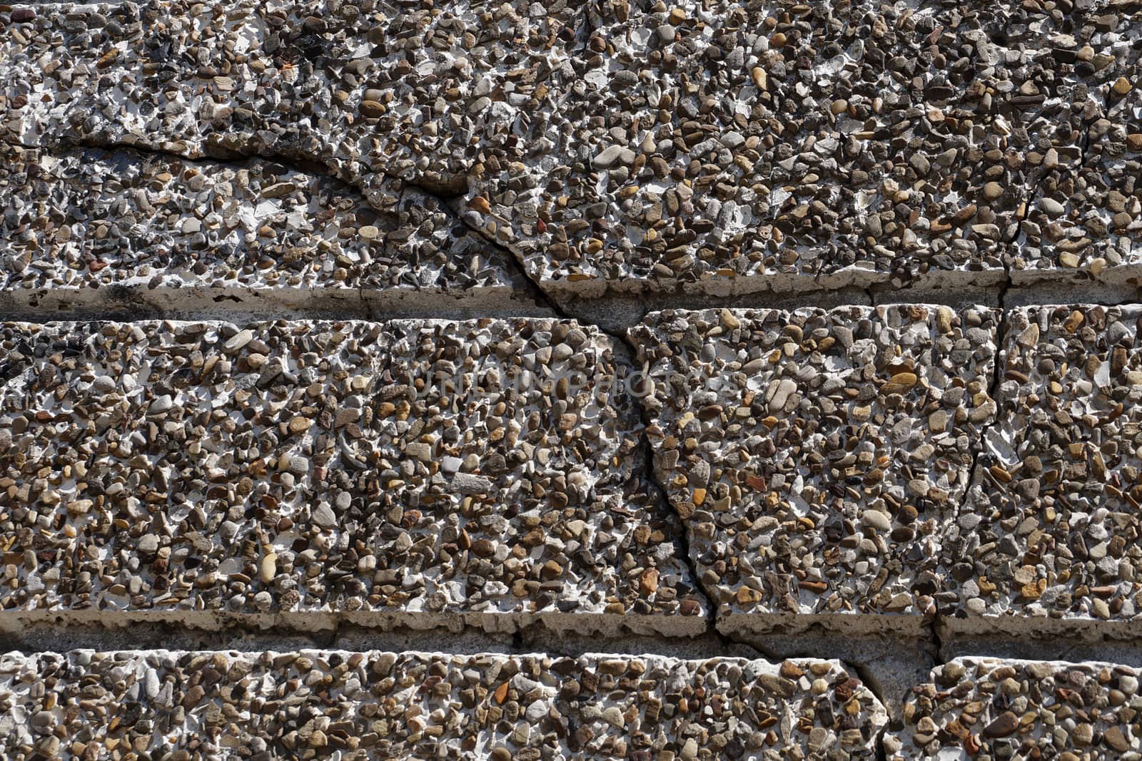 crack in gray stone wall close up by Annado