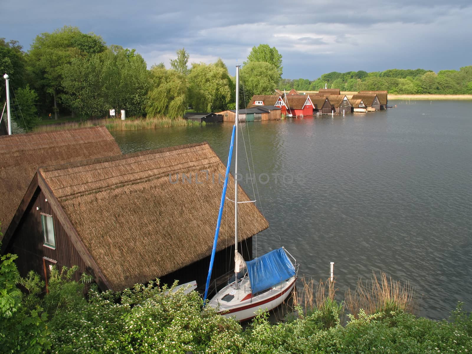 Lake Mueritz with thatched boathouses in Mecklenburg-Western Pomerania, Germany.