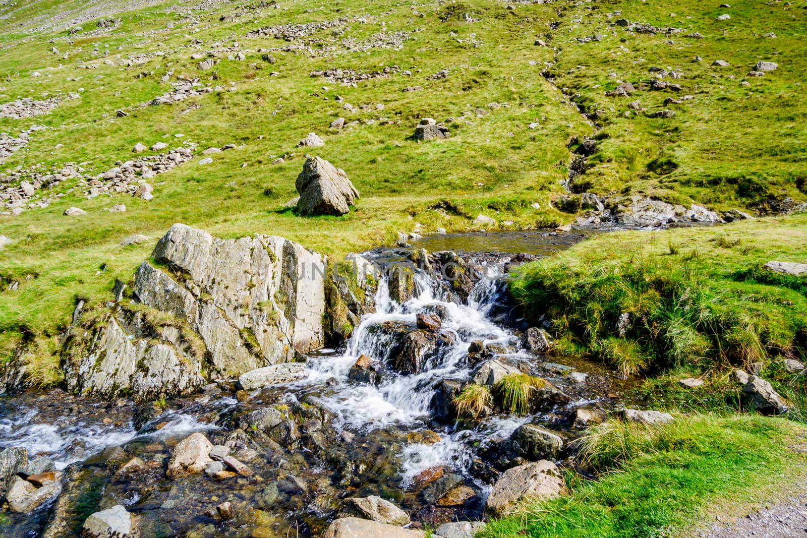 Close up of small waterfall at Kirkstone Pass Lake District by paddythegolfer