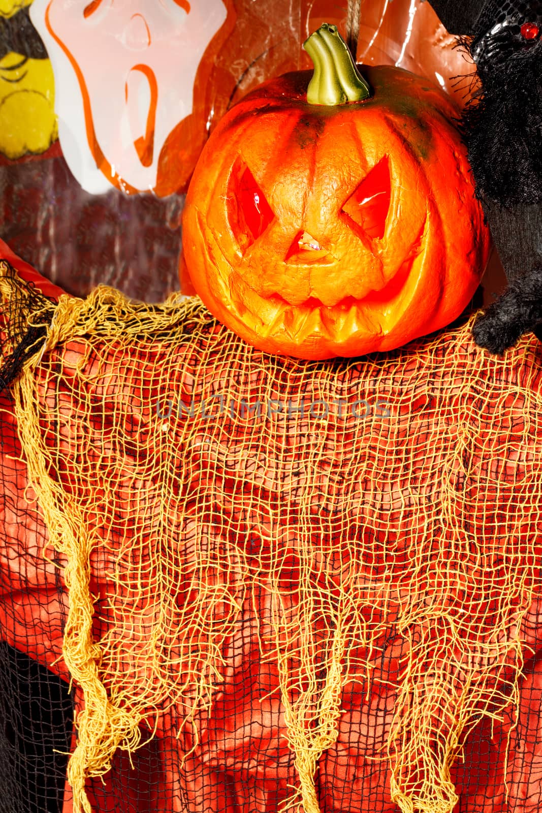 Laughing pumpkin Halloween Jack-o-lantern like ghost with orange and red dress.