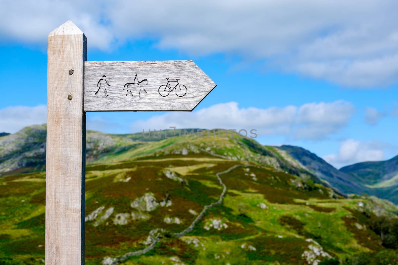 wooden public bridleway sign post on Kirkstone Pass in The Lake District