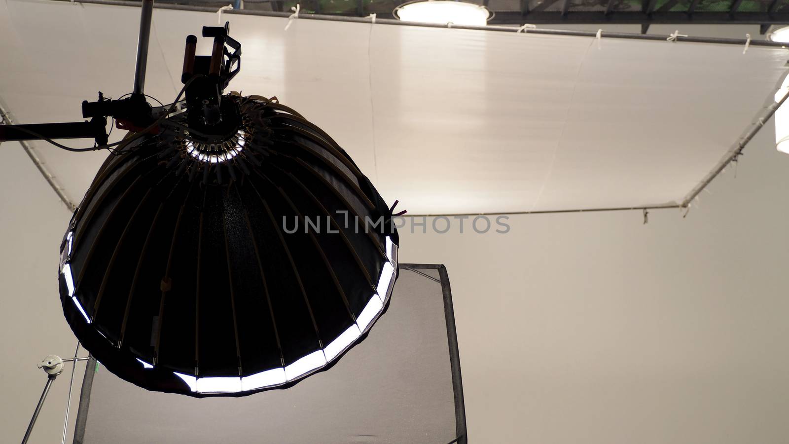 Camera spotlight in big studio. by gnepphoto