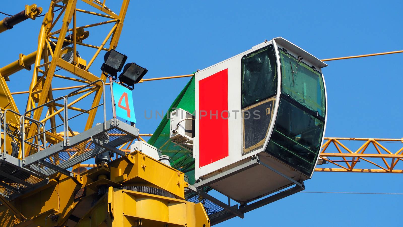 Crane working on construction site and heavy steel material and yellow color and blue sky 