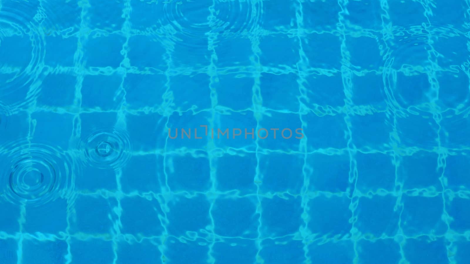 Rain drop falling on pool and have ripple shape and sun light reflection on surface for abstract background. 