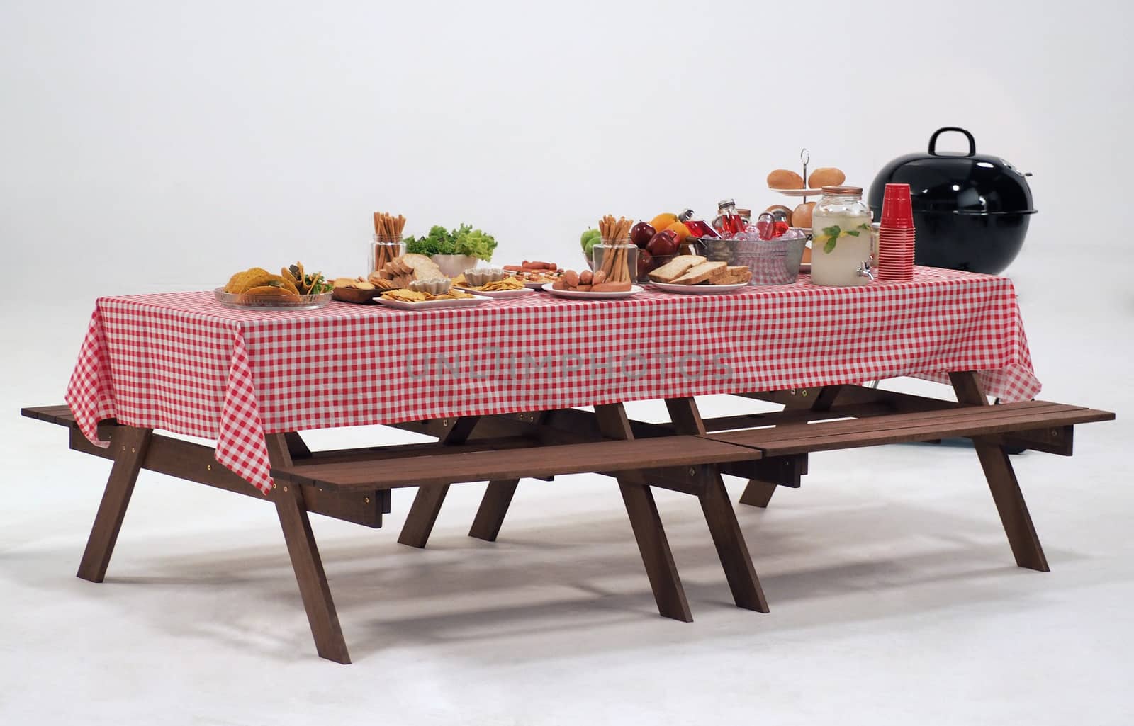 Wood table and red napkin cover for outdoor party or picnic in the garden for summer season and white background.