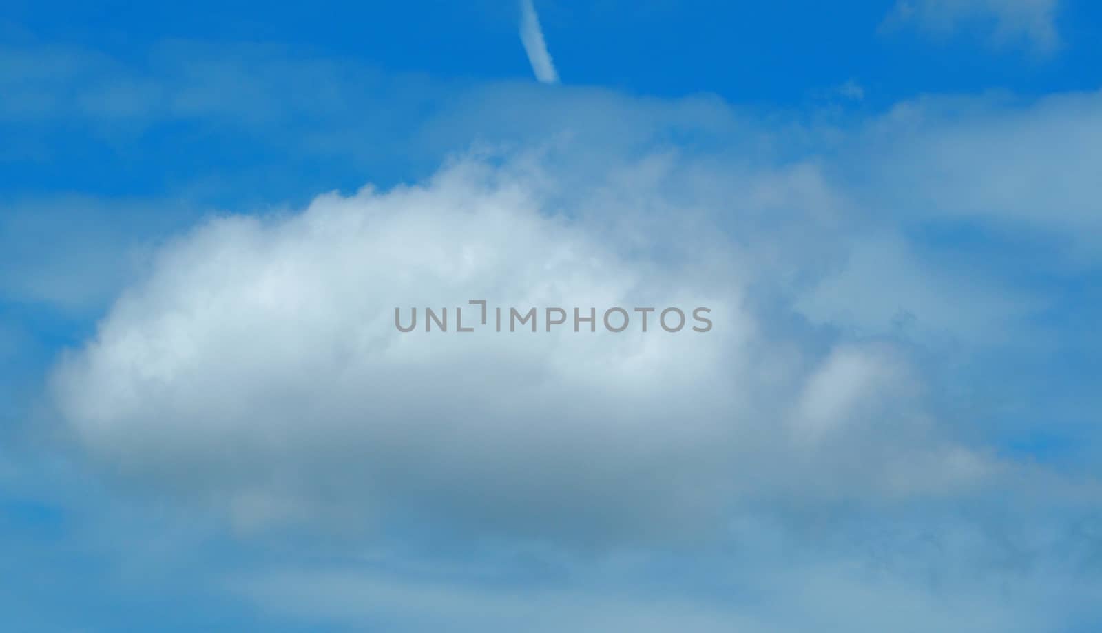 Big white clouds and the blue sky on sunny day and good weather and no rain in summer season.