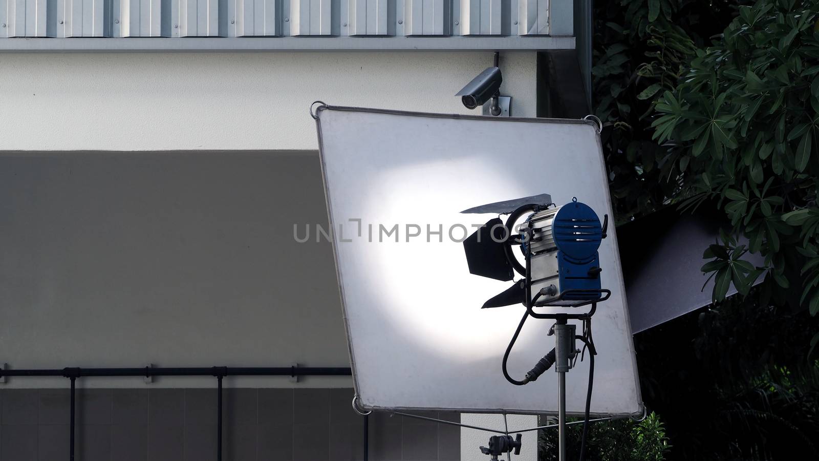 Big studio light and tripod for outdoor movie or video production shooting set.