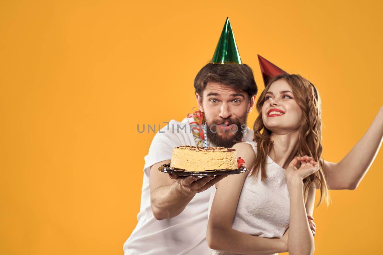 Party man and woman with cake cap birthday celebration by SHOTPRIME