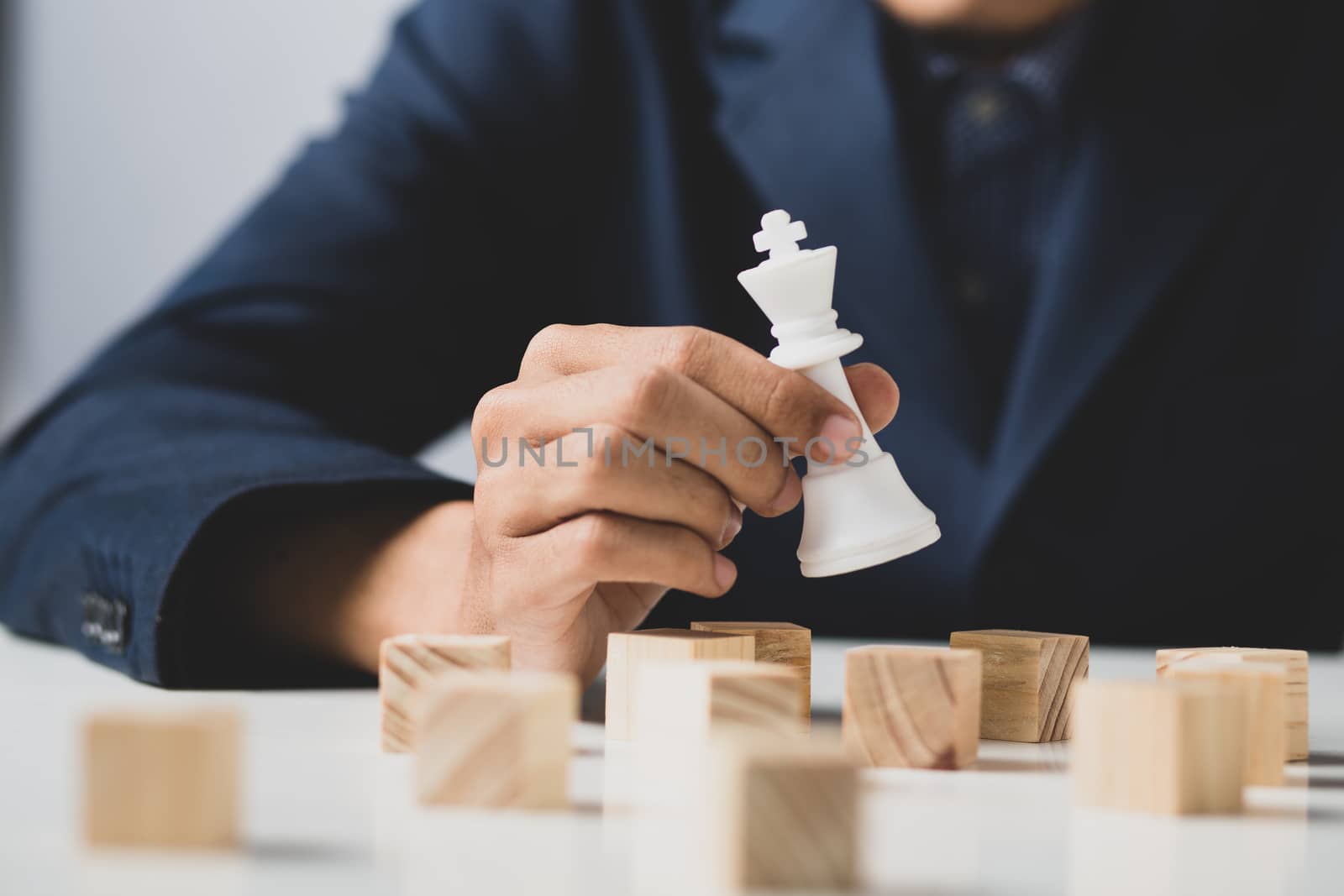 Hands of entrepreneur business man holding wooden blocks placing by golfmhee