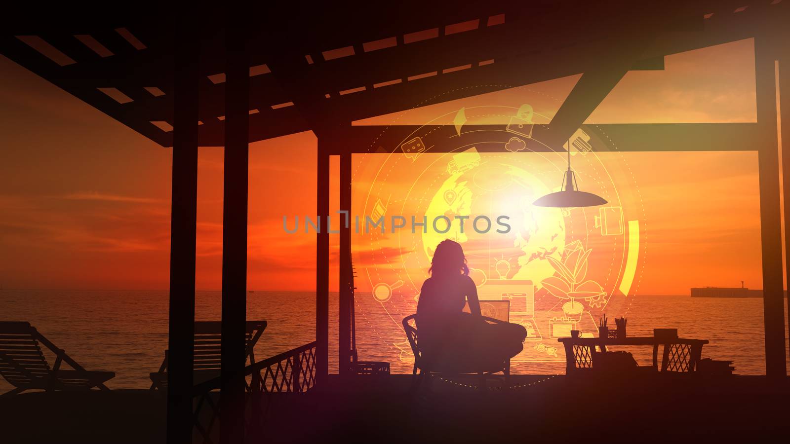 Girl sitting at a laptop by the sea at sunset. by ConceptCafe