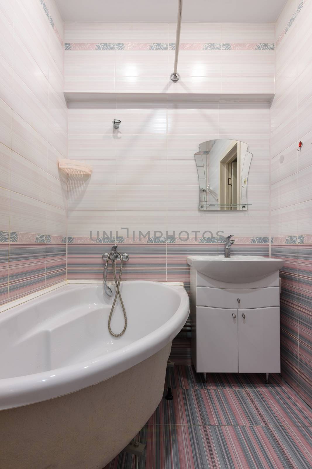 Vertical view of the interior of an ordinary habitable bathroom in the interior of a hotel room