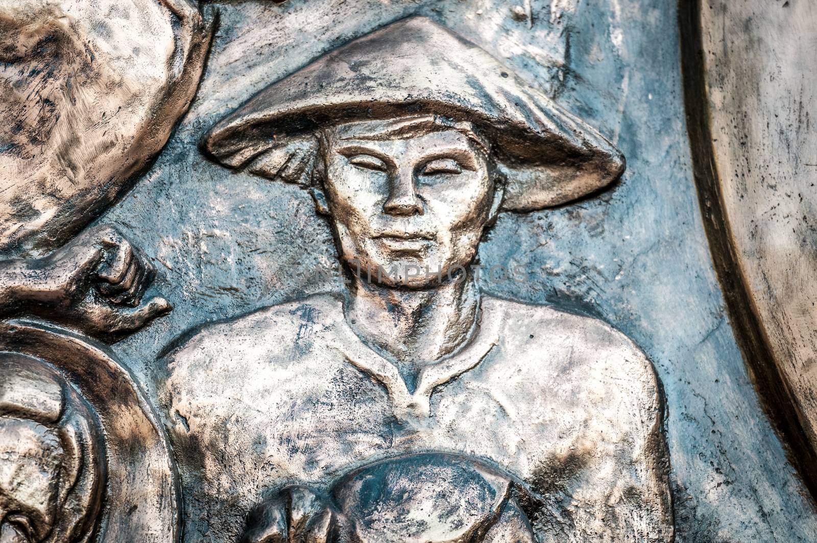 Part of monument with man in hat in Vietnam, Asia. by Yolshin