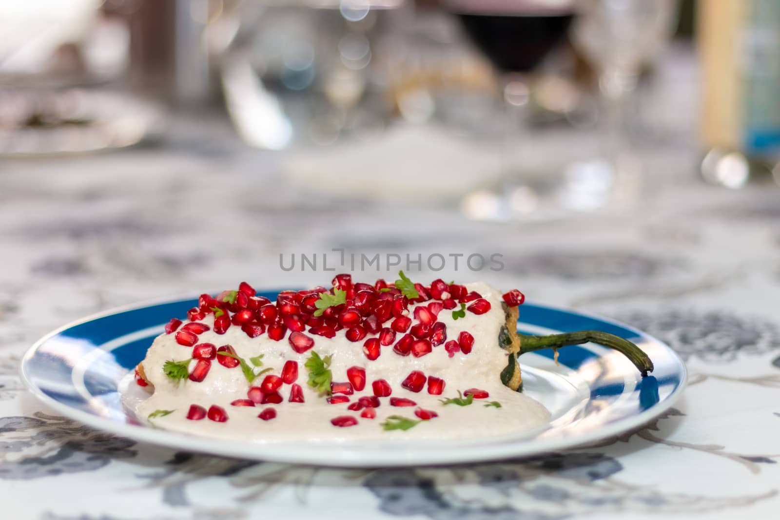 Chile en nogada, traditional festive dish on Mexican Independence Day. Green chili peppers with walnut sauce. by leo_de_la_garza