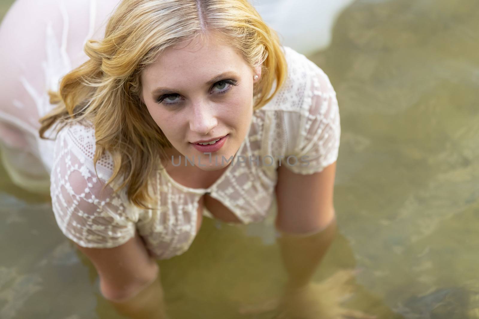 A gorgeous blonde model enjoys the lake on a summers day