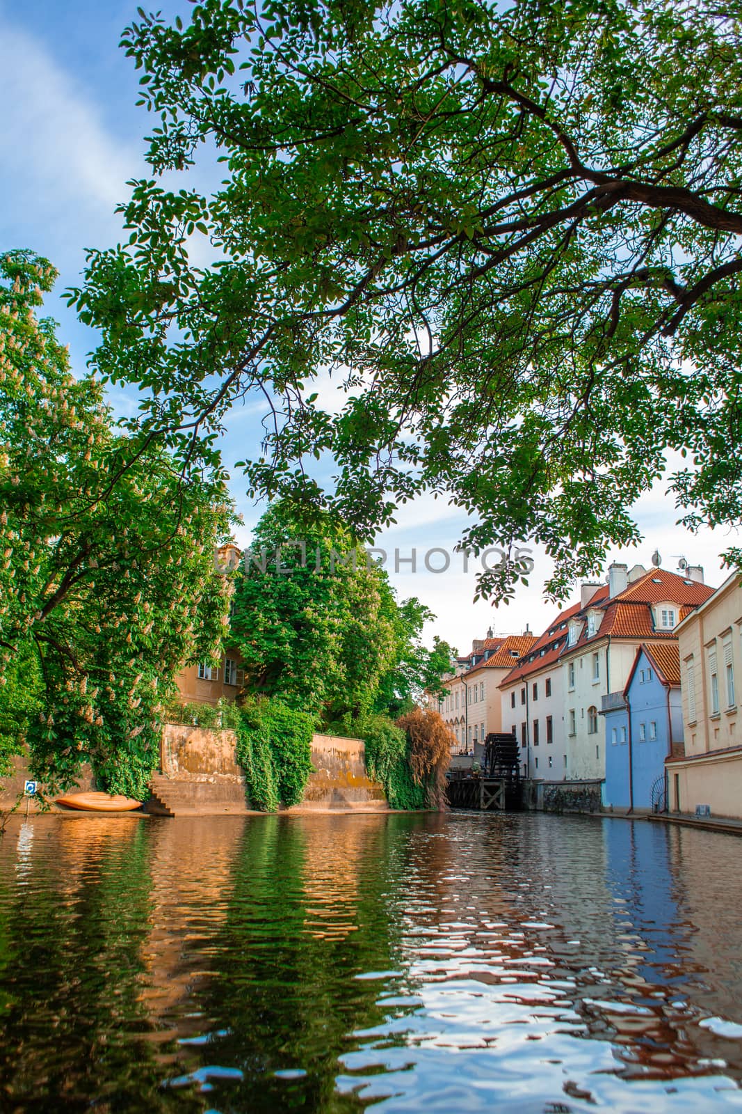 The architecture of the strago city of Prague. River channel in the city. Streets of old Europe, cityscape.