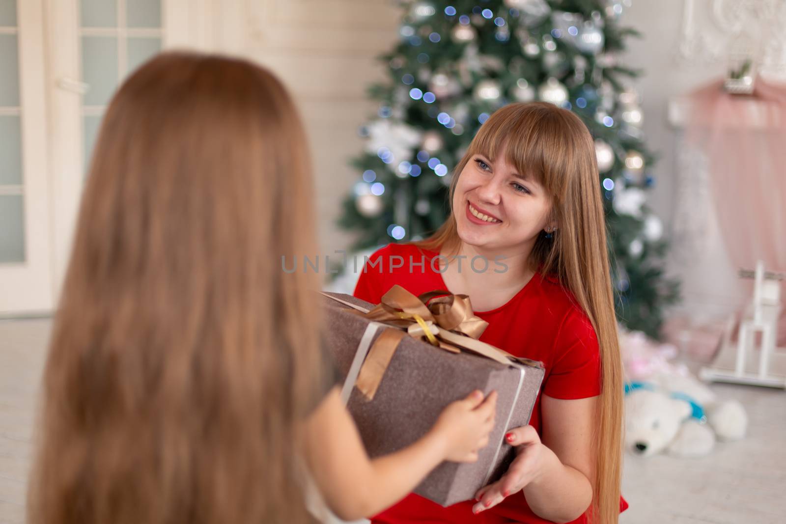 Little girl gives her mom a box with a Christmas present by Try_my_best