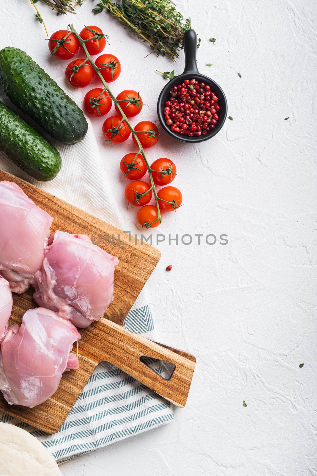 Gyros ingredients, raw chicken meat on white backgroundtop viewwith space for text.