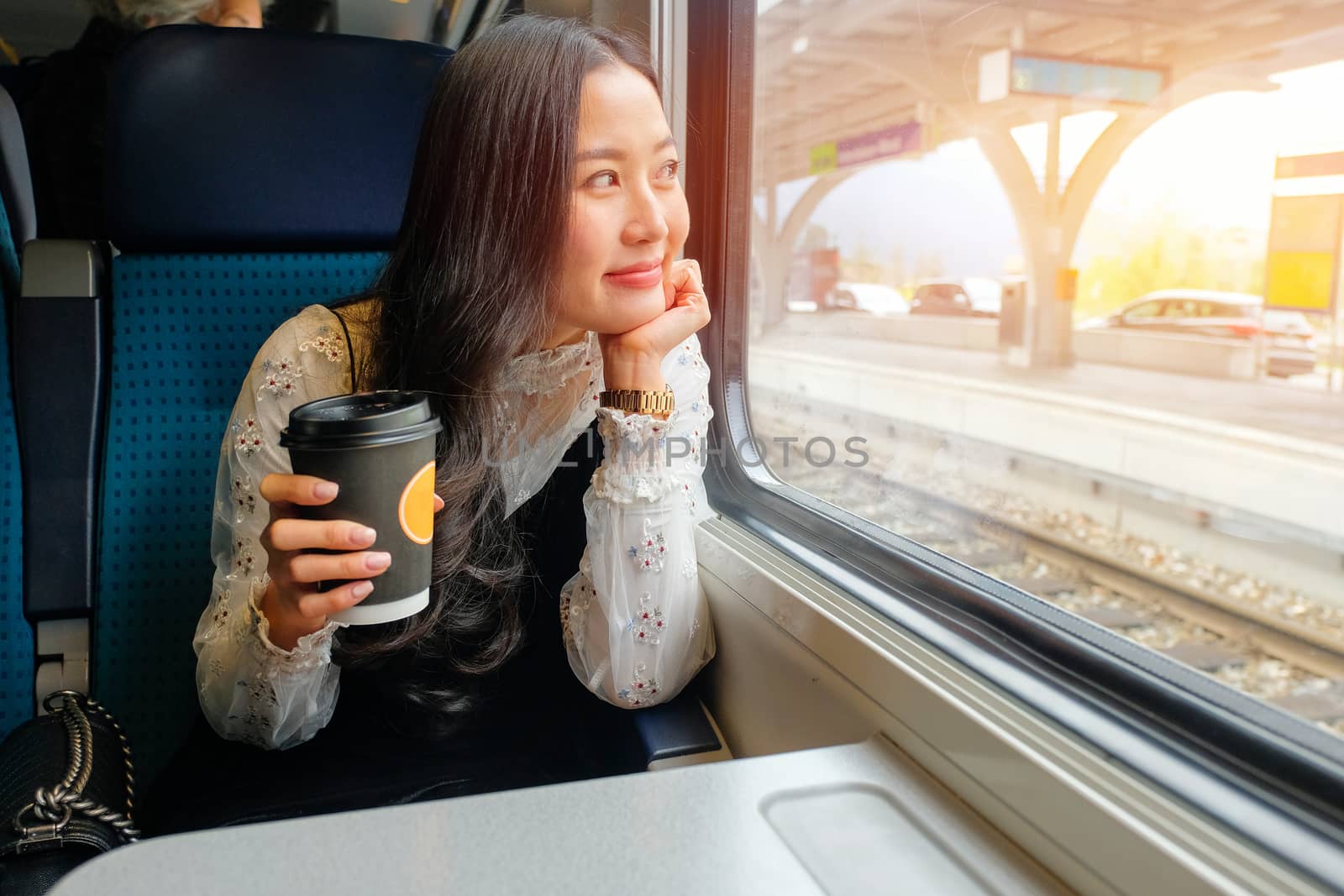Young woman traveling looking view while sitting in the train. by Surasak