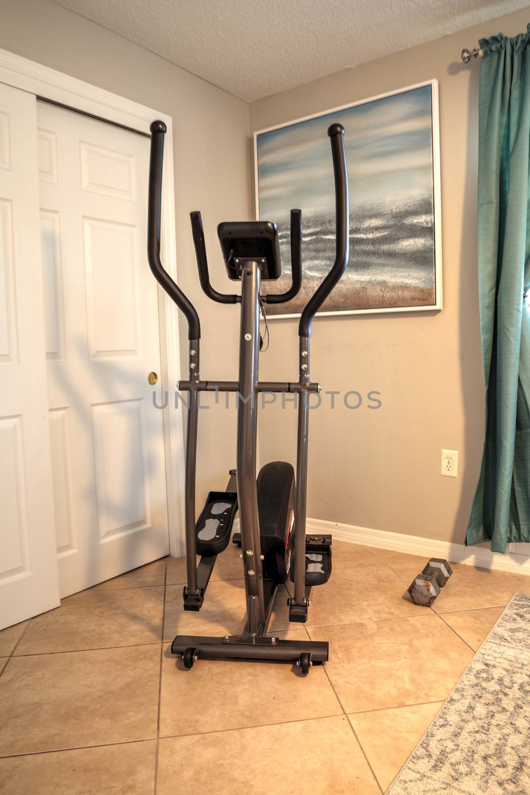Elliptical machine in a home gym for home exercise by steffstarr