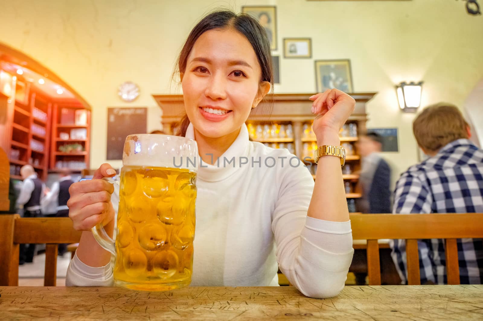 Cute girl drinking beer in Hofbraeuhaus beer house, Munich, Bava by Surasak