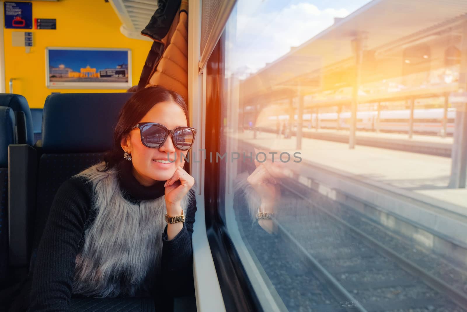 Young woman traveling looking view while sitting in the train. by Surasak