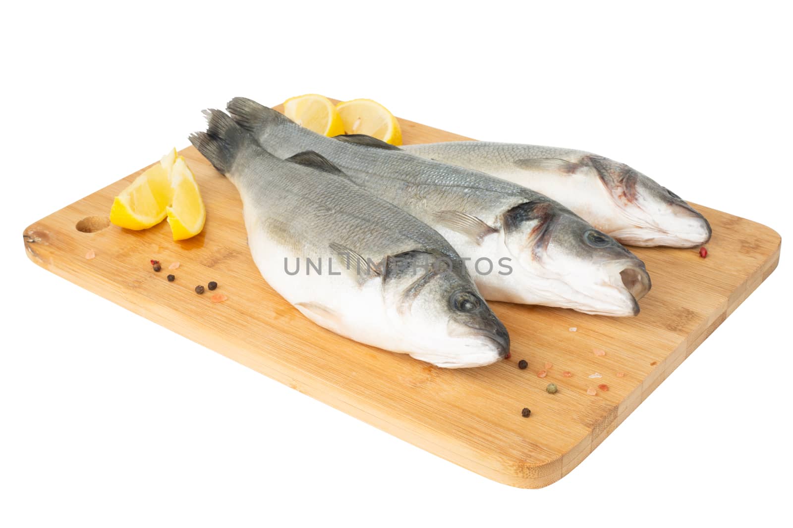 Raw seabass fish on wooden cutting board isolated on white background