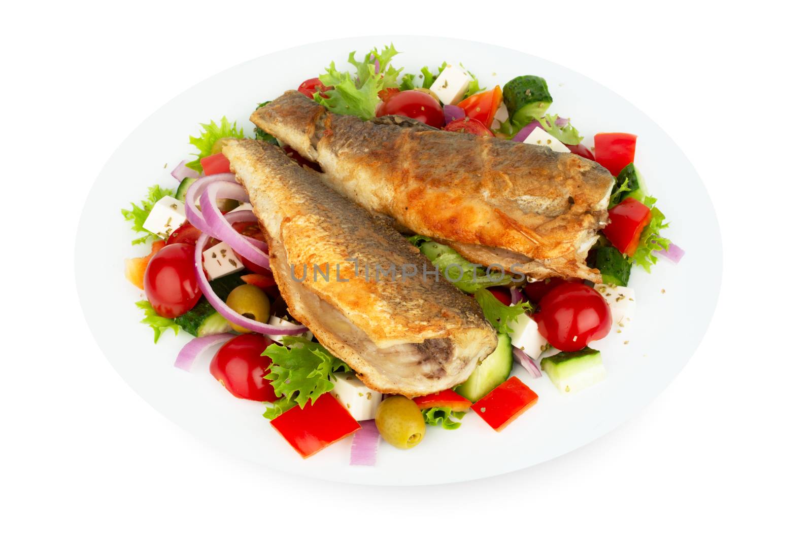 Baked seabass with greek salad mediterranean cuisine on white plate isolated on white background