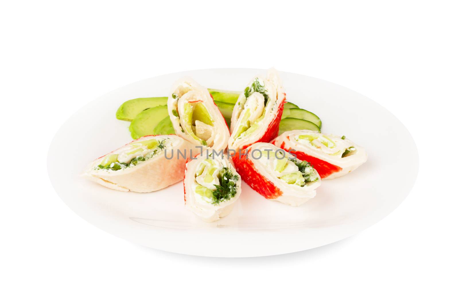 Crab sticks cut meat rolls with vegetables avocado cucumbers sauce on plate isolated on white background