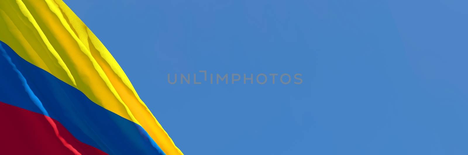 3D rendering of the national flag of Colombia waving in the wind against a blue sky